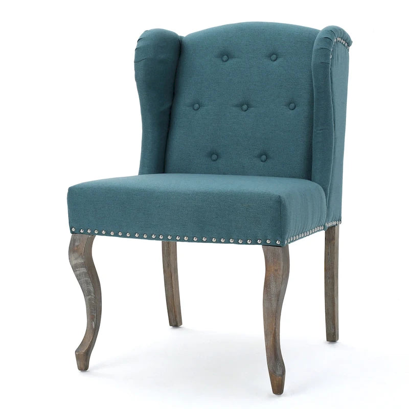 Sillón decorativo de una plaza con respaldo alto, color verde azulado, con botones capitoné y estructura de madera de caucho