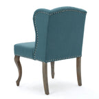 Sillón decorativo de una plaza con respaldo alto, color verde azulado, con botones capitoné y estructura de madera de caucho