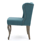Sillón decorativo de una plaza con respaldo alto, color verde azulado, con botones capitoné y estructura de madera de caucho