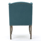 Sillón decorativo de una plaza con respaldo alto, color verde azulado, con botones capitoné y estructura de madera de caucho