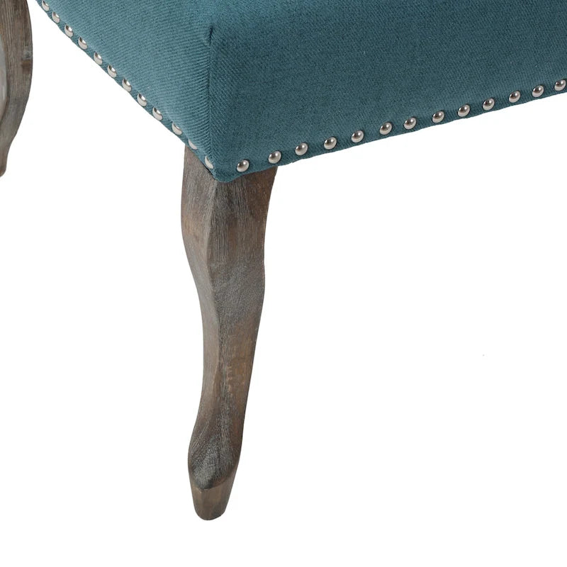 Sillón decorativo de una plaza con respaldo alto, color verde azulado, con botones capitoné y estructura de madera de caucho