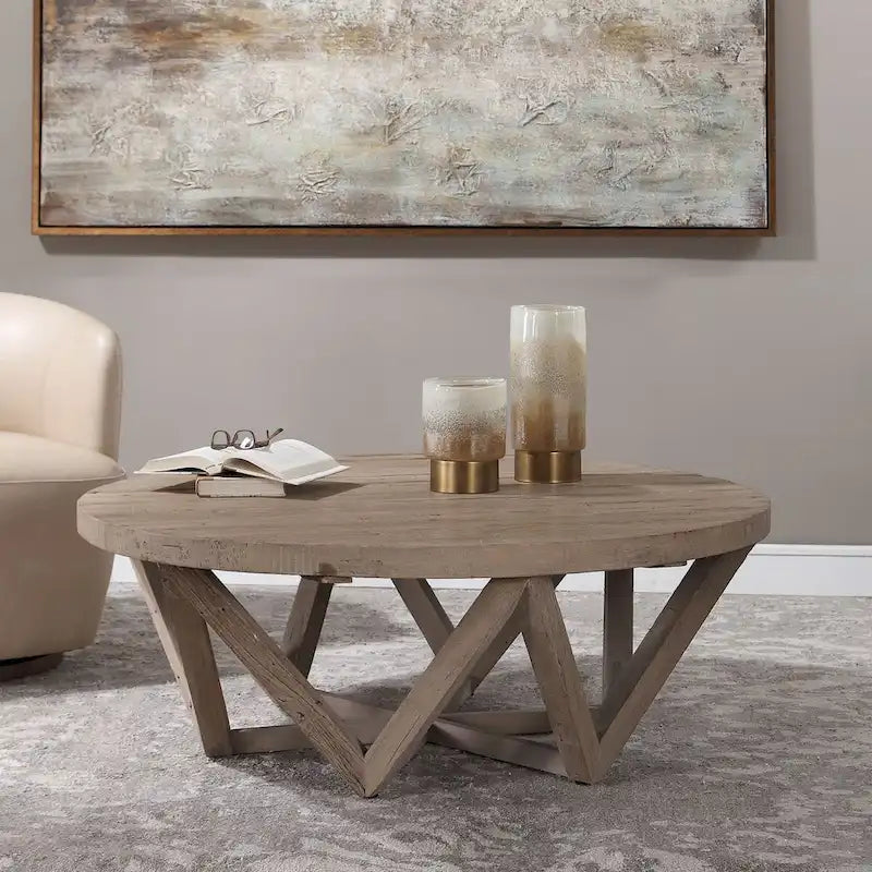Mesa de centro redonda de olmo natural, base geométrica, con capacidad para 4–6 personas