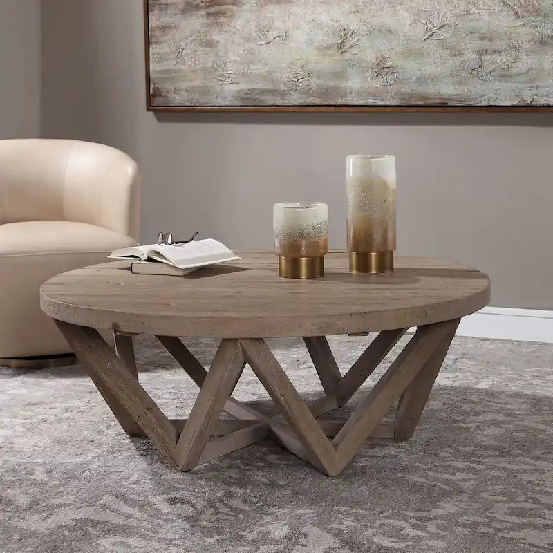 Mesa de centro redonda de olmo natural, base geométrica, con capacidad para 4–6 personas